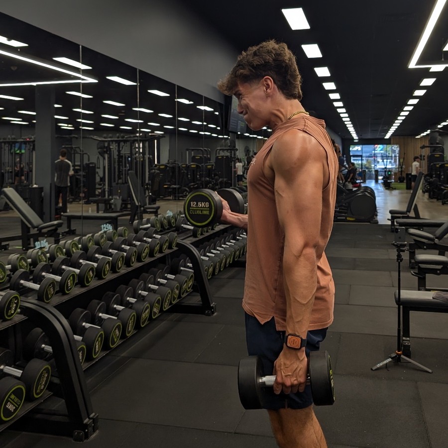 Toby Reeves doing dumbbell curls at the gym