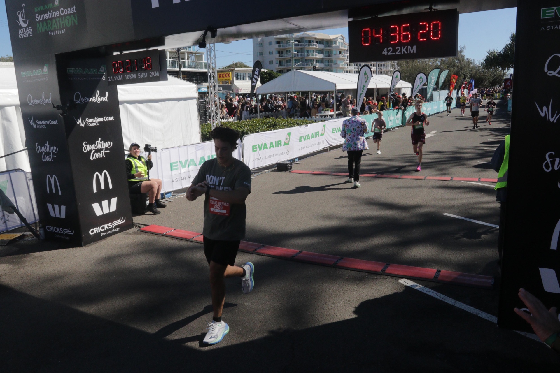 Toby Reeves crossing the Sunshine Coast Marathon finish line